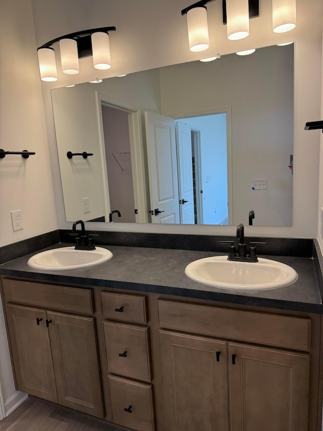 full bath with a sink and double vanity