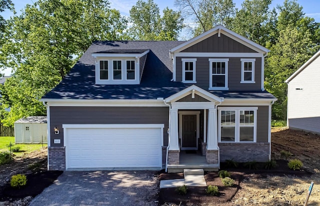603 Mill Stone Dr Lot 2257, Sunbury, OH 43074 - craftsman-style house with driveway, an attached garage, roof with shingles, brick siding, and board and batten siding
