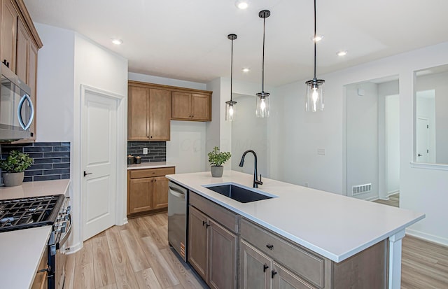 603 Mill Stone Dr Lot 2257, Sunbury, OH 43074 - kitchen with a sink, stainless steel appliances, light wood finished floors, tasteful backsplash, and light countertops