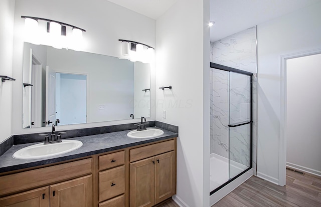 603 Mill Stone Dr Lot 2257, Sunbury, OH 43074 - bathroom featuring a marble finish shower, double vanity, wood finished floors, and baseboards