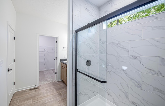 603 Mill Stone Dr Lot 2257, Sunbury, OH 43074 - full bath featuring a marble finish shower, vanity, a walk in closet, wood finished floors, and baseboards