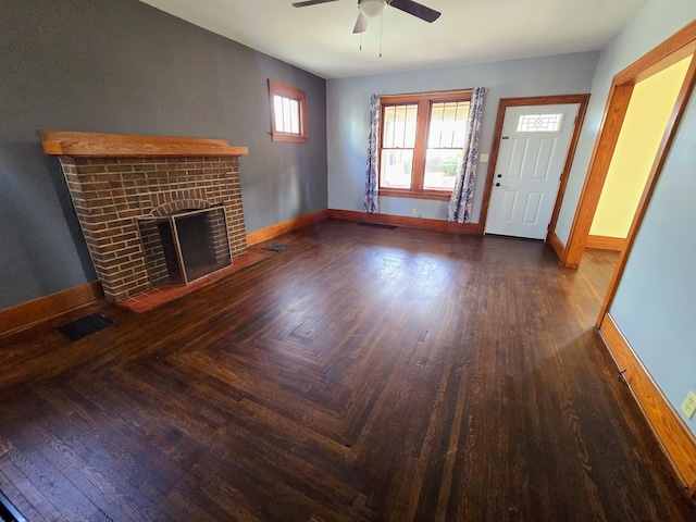 unfurnished living room featuring a brick fireplace, visible vents, and baseboards