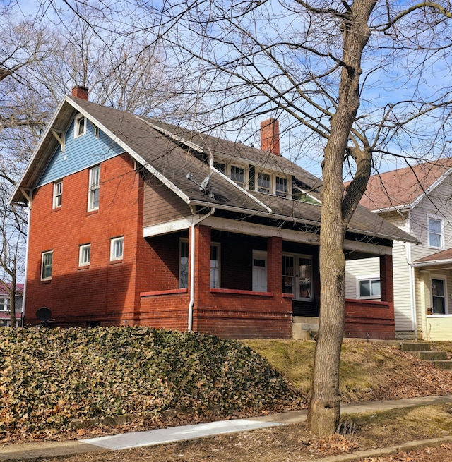 view of property exterior featuring brick siding and a chimney