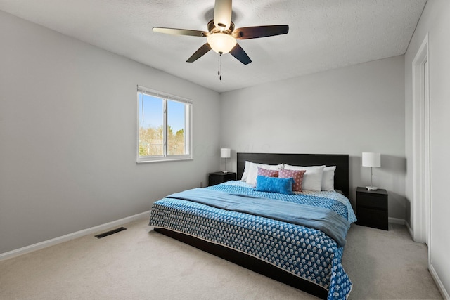 bedroom with visible vents, baseboards, carpet, and a ceiling fan