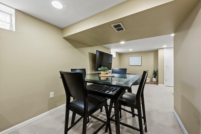 dining room featuring recessed lighting, baseboards, visible vents, and light carpet