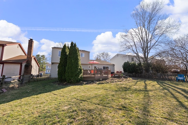 view of yard featuring fence and a wooden deck