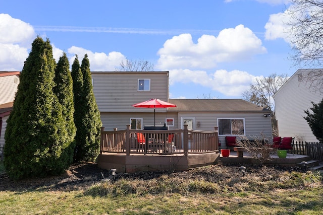 rear view of house featuring a wooden deck