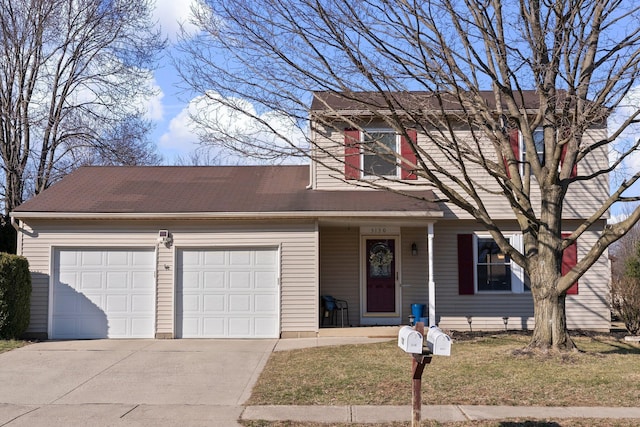 traditional home with concrete driveway, an attached garage, and a front yard