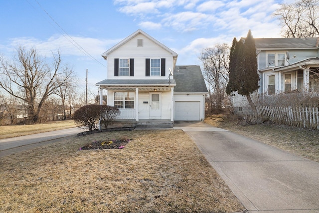 traditional home with a garage, covered porch, and concrete driveway