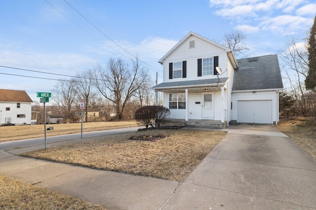 traditional-style house with covered porch, driveway, a shingled roof, and an attached garage