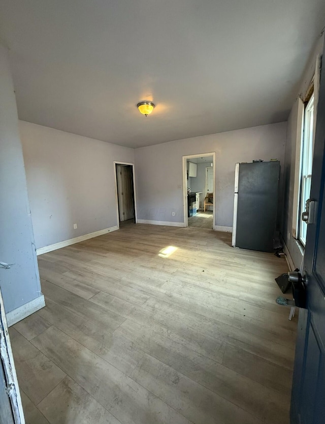 interior space with light wood-style flooring and baseboards