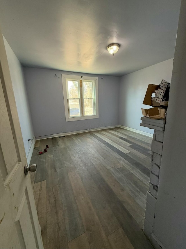 interior space with wood finished floors and baseboards