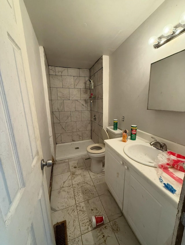 bathroom featuring toilet, a stall shower, visible vents, and vanity