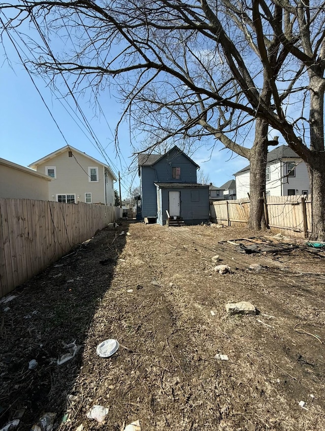 view of yard with a fenced backyard and an outbuilding