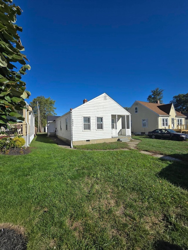 rear view of property with a lawn