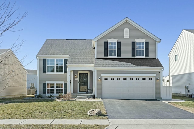 view of front of property with a front yard, an attached garage, driveway, and a shingled roof