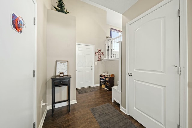 hall featuring dark wood finished floors and baseboards