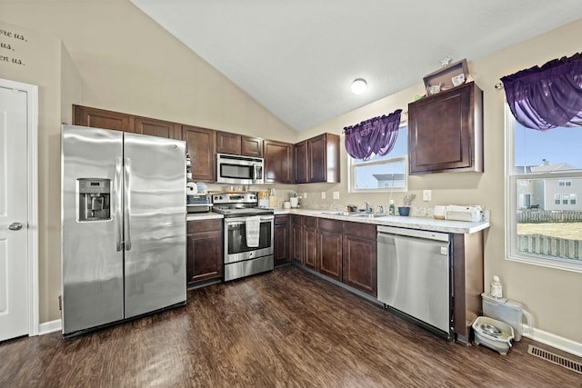 kitchen featuring dark wood-style floors, visible vents, a sink, stainless steel appliances, and light countertops