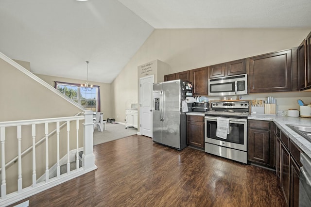 kitchen featuring dark wood-style floors, stainless steel appliances, light countertops, dark brown cabinets, and decorative light fixtures