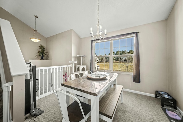 dining area with baseboards, lofted ceiling, carpet floors, and an inviting chandelier