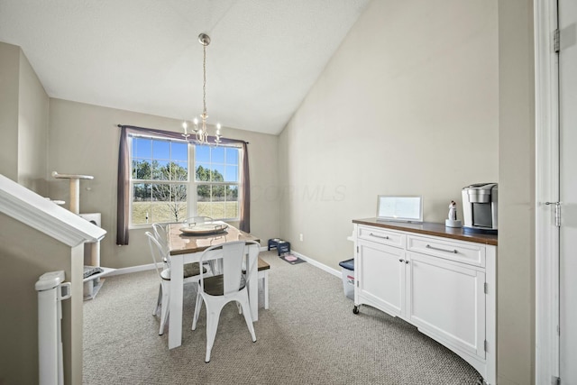 dining space featuring lofted ceiling, a notable chandelier, baseboards, and light carpet