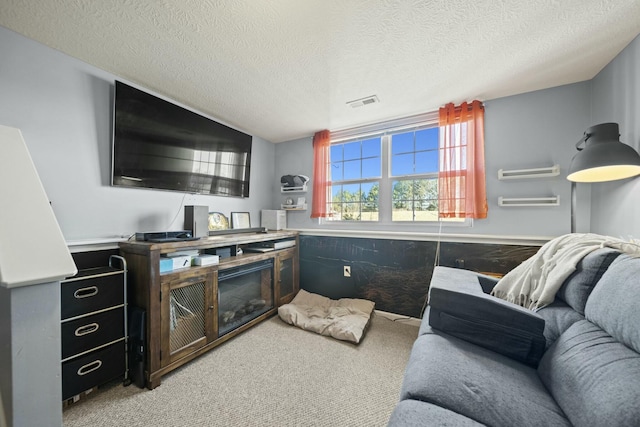 interior space with visible vents, carpet floors, and a textured ceiling