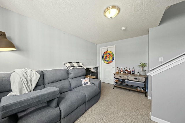 living area with baseboards, carpet floors, and a textured ceiling