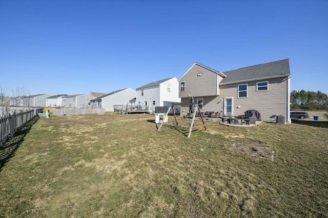 view of yard with central air condition unit, a residential view, and fence