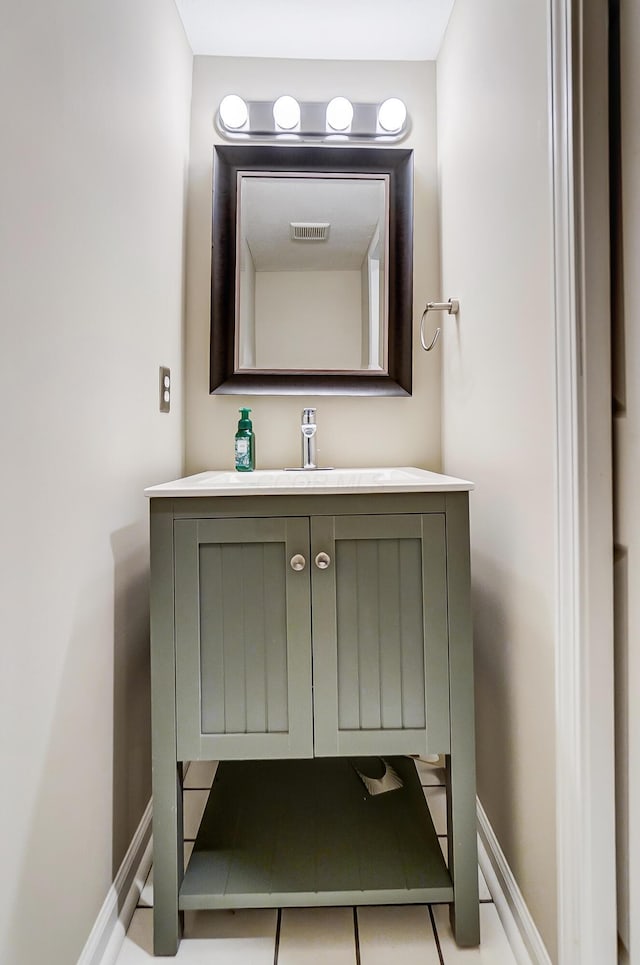 bathroom featuring visible vents, vanity, and baseboards