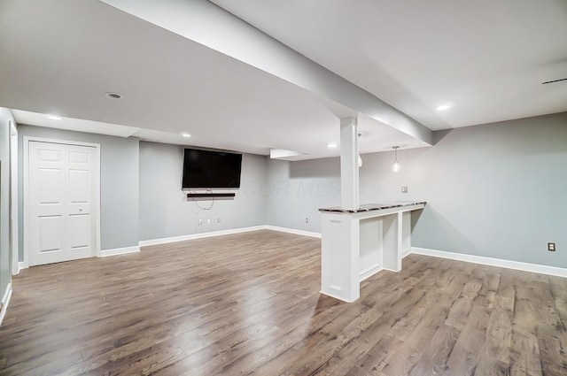 finished basement with baseboards, wood finished floors, and recessed lighting