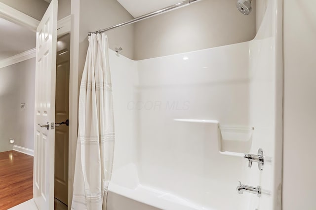 full bathroom with shower / tub combo with curtain and wood finished floors