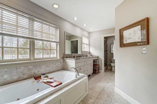 bathroom featuring toilet, recessed lighting, vanity, tile patterned floors, and a tub with jets