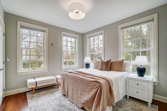 bedroom with baseboards and wood finished floors