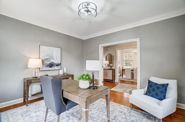 home office featuring baseboards, wood finished floors, and an inviting chandelier