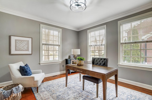 home office with baseboards, visible vents, ornamental molding, wood finished floors, and a chandelier