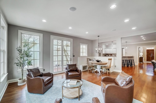 living room featuring baseboards, wood finished floors, and recessed lighting