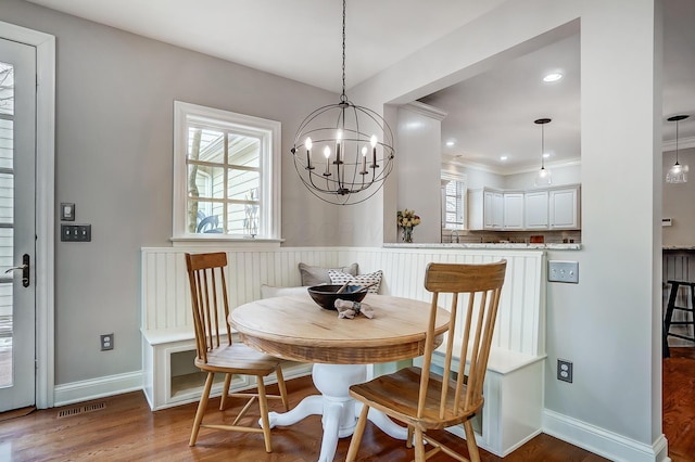 dining area featuring plenty of natural light, visible vents, breakfast area, and wood finished floors