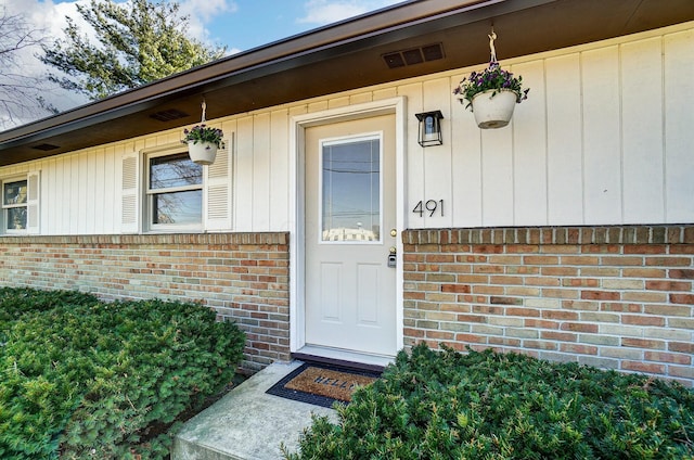 entrance to property with brick siding