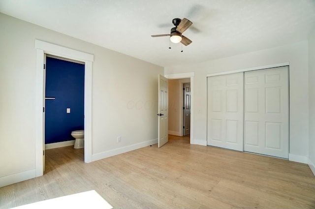 unfurnished bedroom with ensuite bath, light wood-style floors, baseboards, and a closet