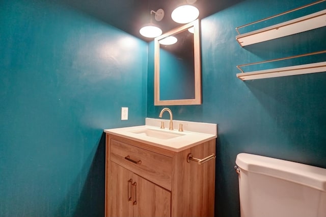 bathroom featuring toilet and vanity