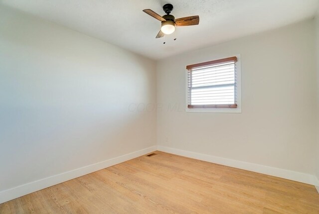 unfurnished room featuring ceiling fan, visible vents, baseboards, and light wood-style flooring