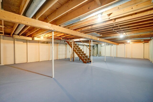 unfinished basement featuring stairway