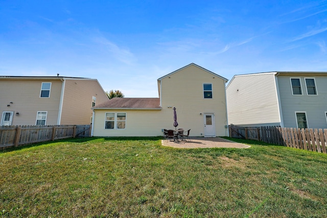 back of house with a yard, a patio, and a fenced backyard