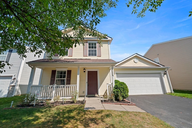 traditional-style home with a porch, a garage, and aphalt driveway