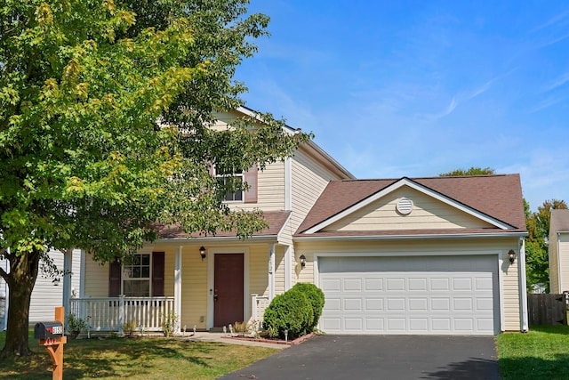 view of front facade featuring a front lawn, covered porch, driveway, and an attached garage