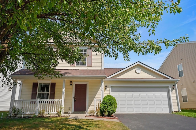 traditional-style home with a porch, driveway, and an attached garage