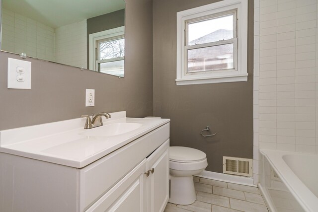 full bath featuring tile patterned flooring, toilet, vanity, visible vents, and baseboards