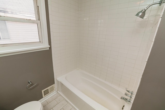 bathroom featuring toilet, bathing tub / shower combination, and visible vents