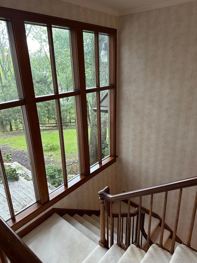 stairway featuring wallpapered walls and ornamental molding