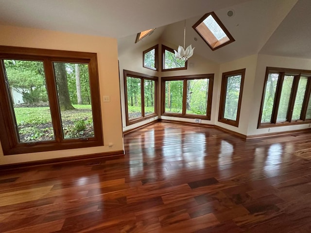 interior space featuring high vaulted ceiling, a notable chandelier, wood finished floors, visible vents, and baseboards